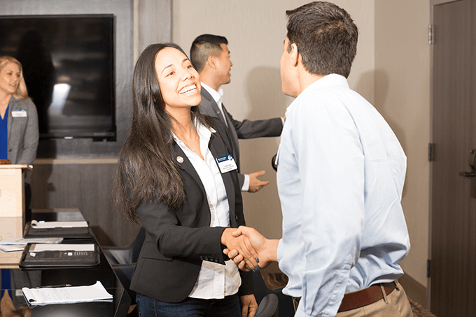 Heart Filled Toastmaster members shaking hands at a meeting